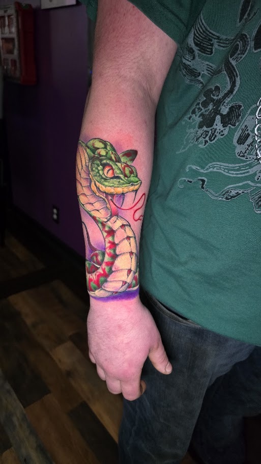 Full color snake forearm tattoo by Billy Smith