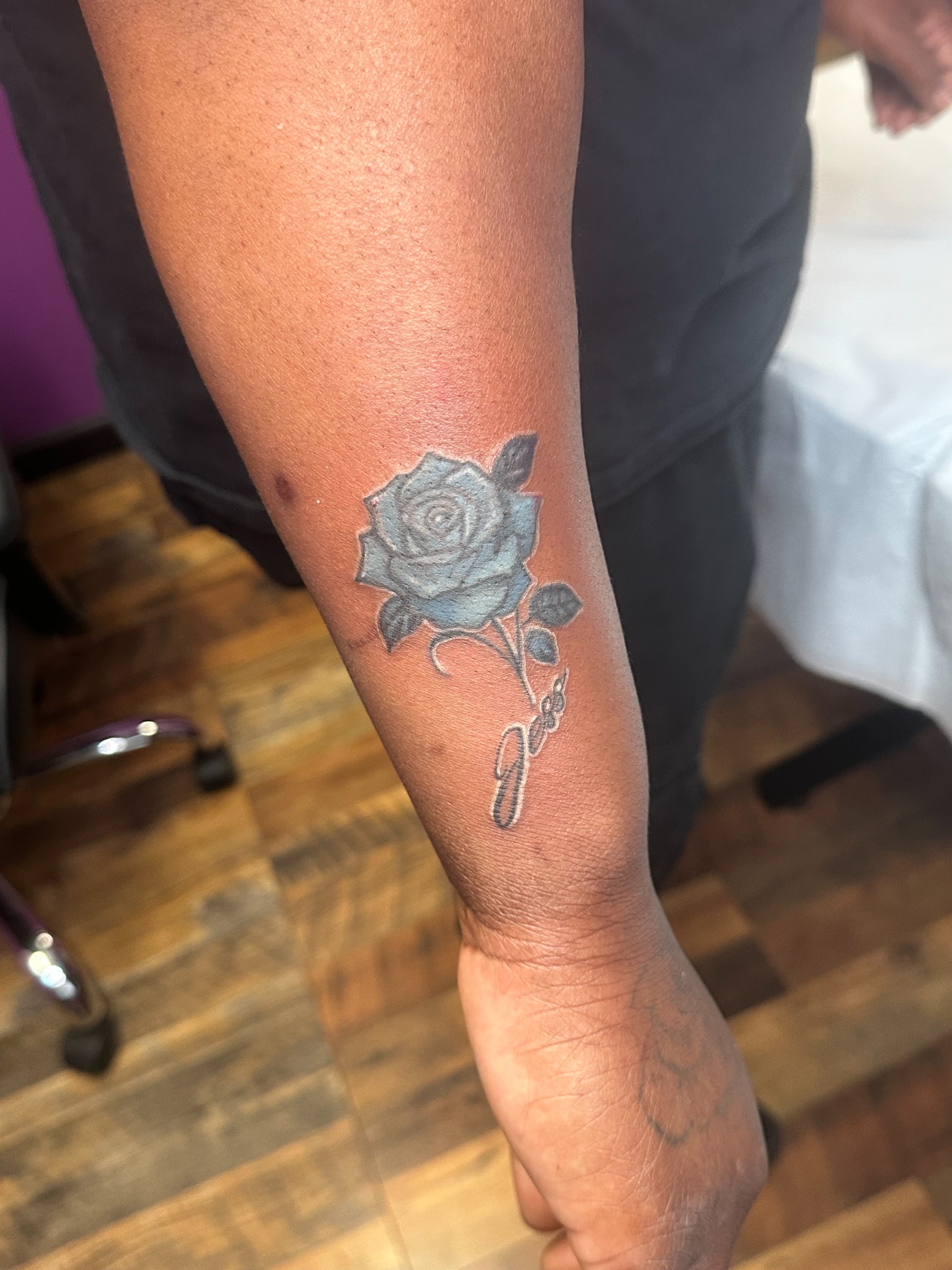 Black and grey rose forearm tattoo by Blady